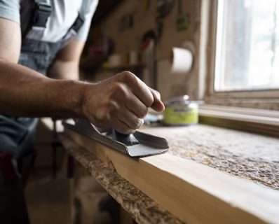 carpenter-cutting-mdf-board-inside-workshop 1