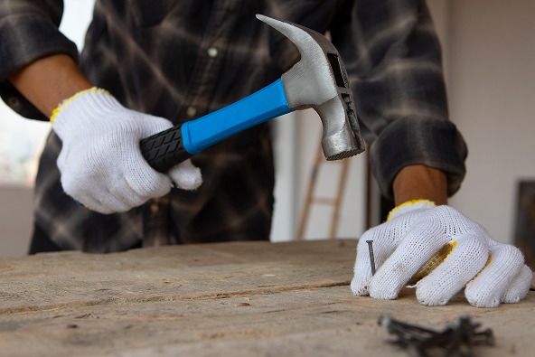 construction-worker-using-hammer-job-site 1